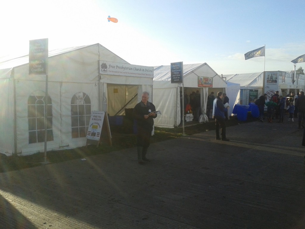 The Free Presbyterian marquee with two of the brethren handing out gospel calendars and literature