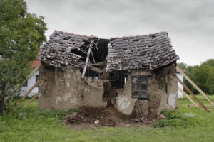 28456803-ruined-house-propped-and-with-broken-roof